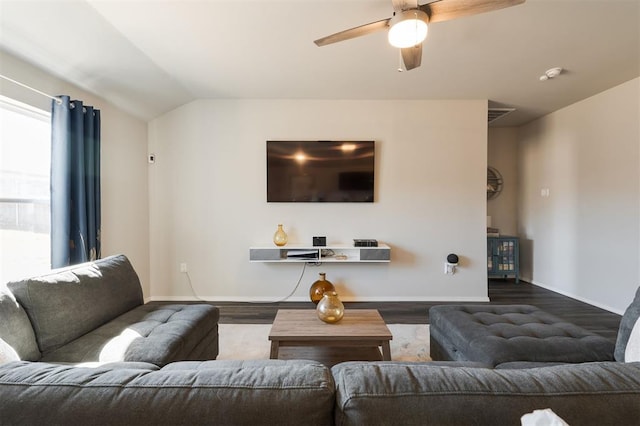 living area with vaulted ceiling, wood finished floors, and baseboards