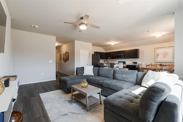 living room with lofted ceiling, visible vents, ceiling fan, wood finished floors, and baseboards