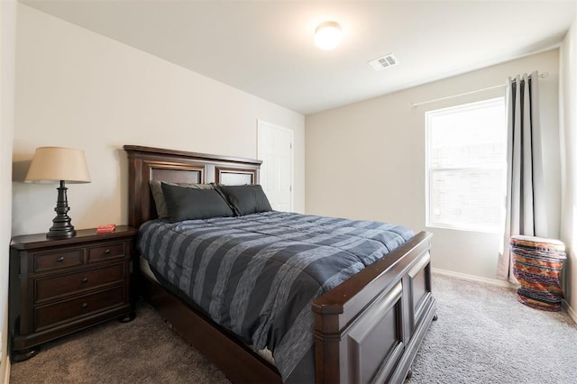 carpeted bedroom featuring visible vents and baseboards