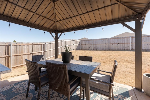 view of patio / terrace with outdoor dining area, a fenced backyard, and a gazebo