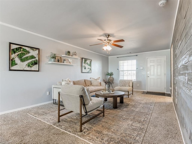 living room with ornamental molding, ceiling fan, and baseboards