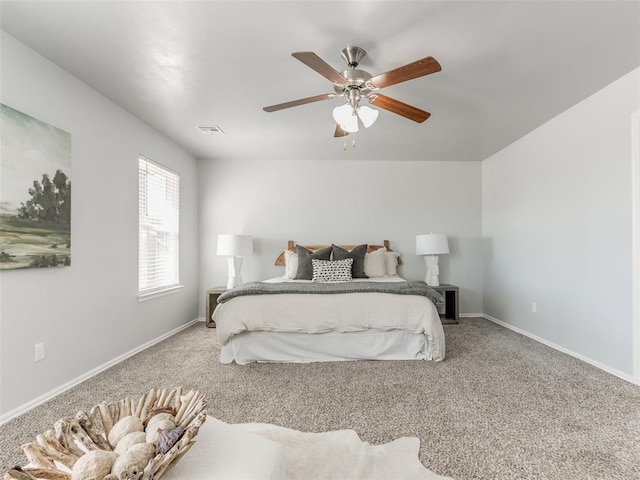 carpeted bedroom featuring visible vents, ceiling fan, and baseboards