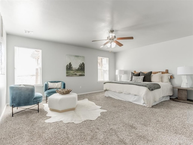 carpeted bedroom with baseboards, visible vents, and a ceiling fan