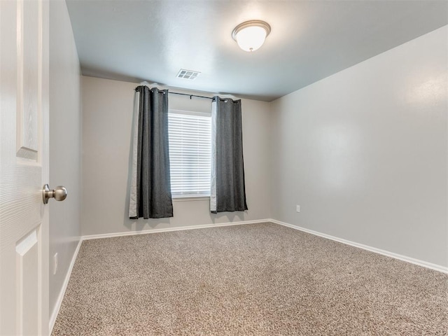 carpeted empty room featuring visible vents and baseboards