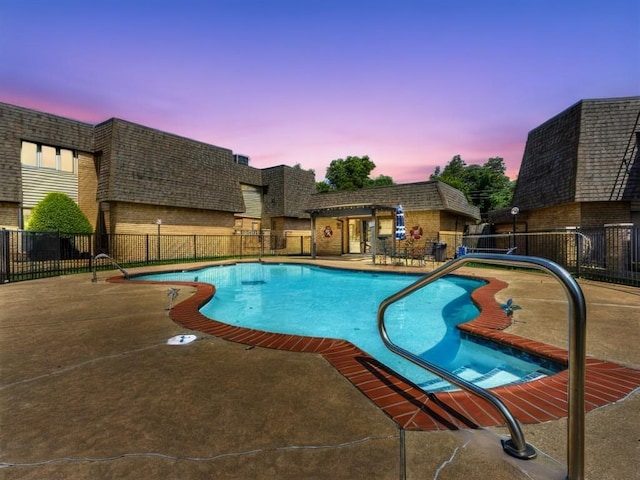 community pool featuring a patio and fence