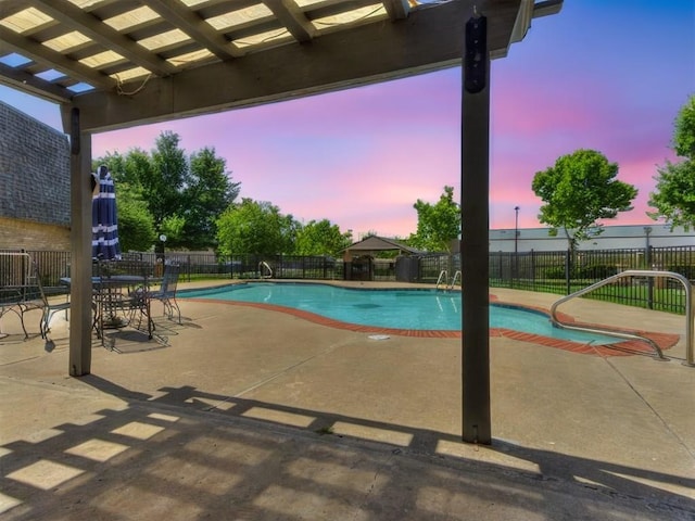 pool at dusk with a fenced in pool, a patio, and fence