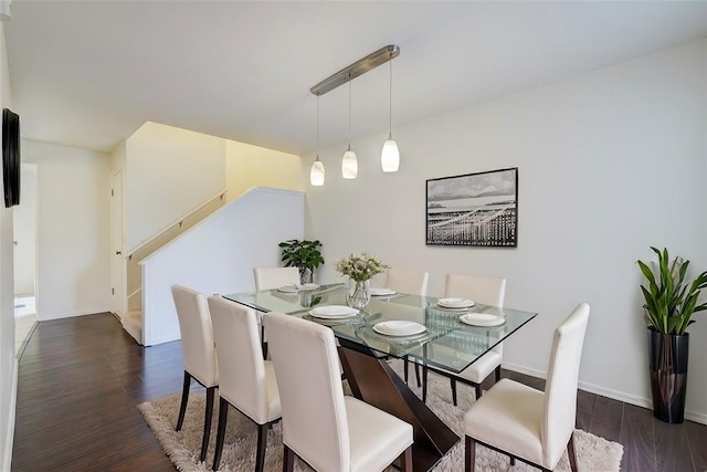 dining room with stairway, baseboards, and dark wood finished floors