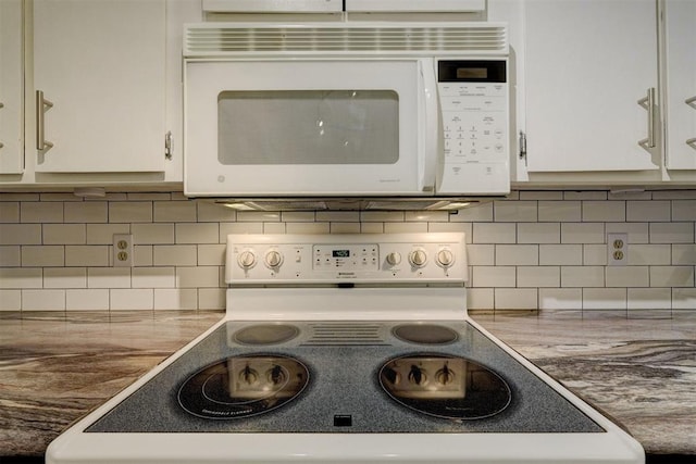 room details featuring electric stove, white cabinets, backsplash, and white microwave