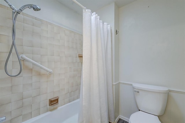 full bath with shower / bath combo with shower curtain and toilet