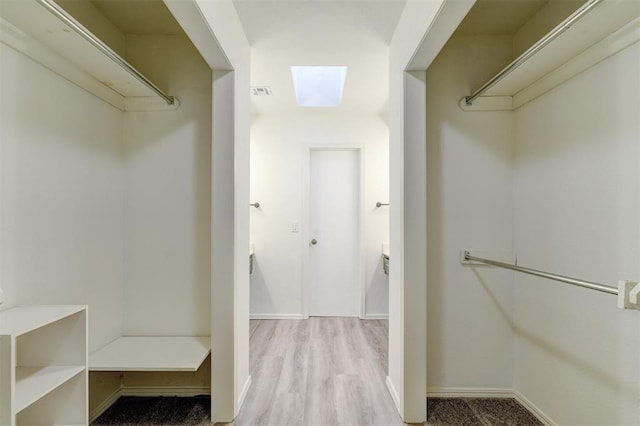 spacious closet featuring wood finished floors and visible vents