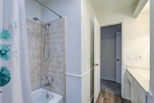 bathroom with shower / tub combo, wood finished floors, and vanity