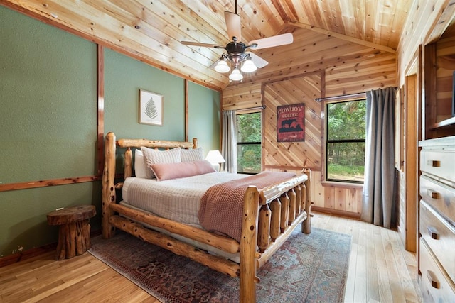 bedroom with lofted ceiling, wood ceiling, wood walls, and hardwood / wood-style floors