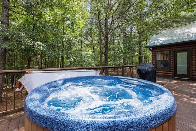 wooden deck with a grill and a hot tub