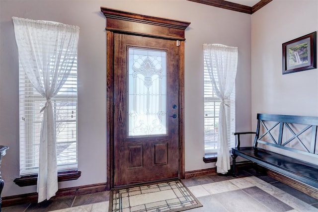 entrance foyer featuring baseboards and ornamental molding