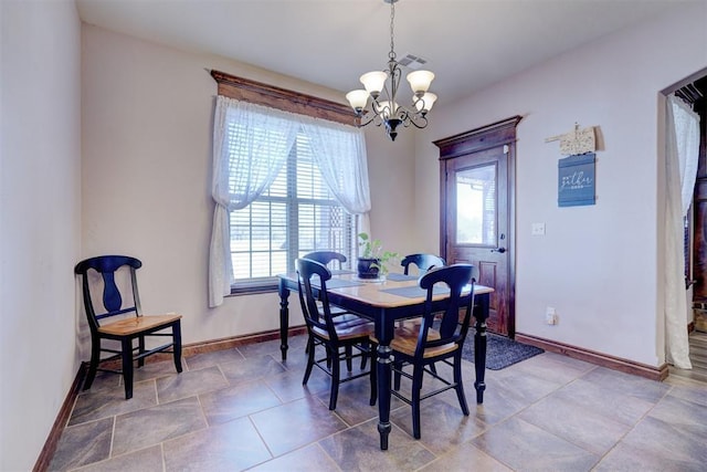 dining area featuring baseboards, visible vents, and a notable chandelier