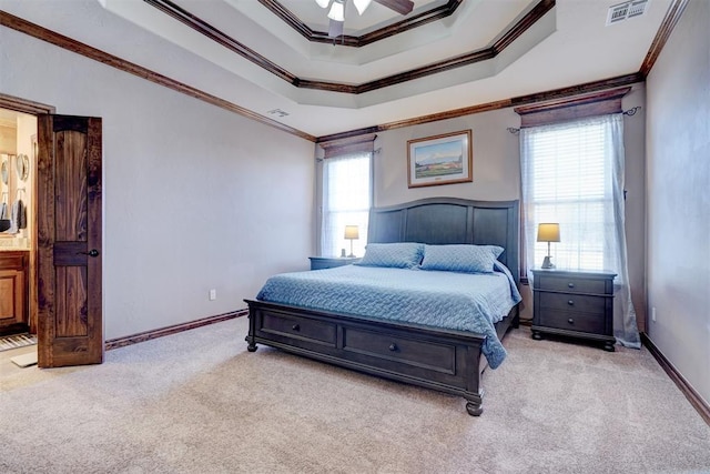 bedroom featuring a raised ceiling, visible vents, light carpet, and multiple windows