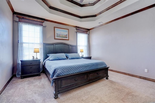 bedroom with a raised ceiling, carpet flooring, and crown molding