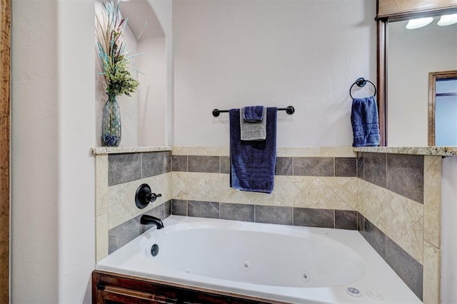 full bathroom featuring a tub with jets