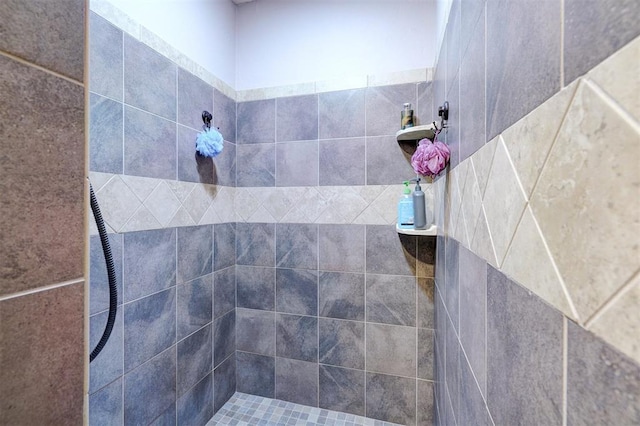 bathroom with a tile shower