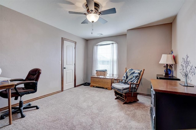 home office featuring light colored carpet, ceiling fan, visible vents, and baseboards