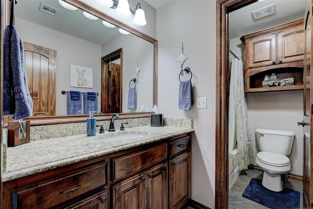 bathroom featuring shower / tub combo, visible vents, vanity, and toilet