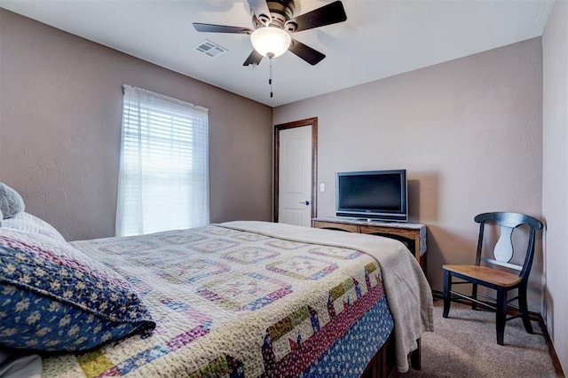 carpeted bedroom with visible vents and a ceiling fan