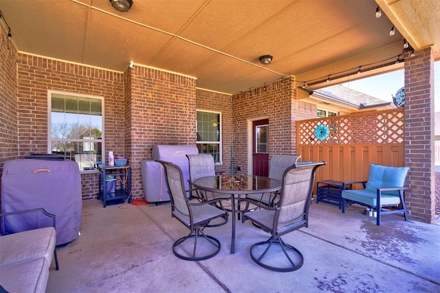 view of patio / terrace featuring fence and outdoor dining space