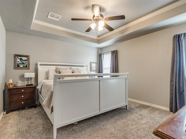 bedroom featuring a tray ceiling, carpet flooring, visible vents, and baseboards