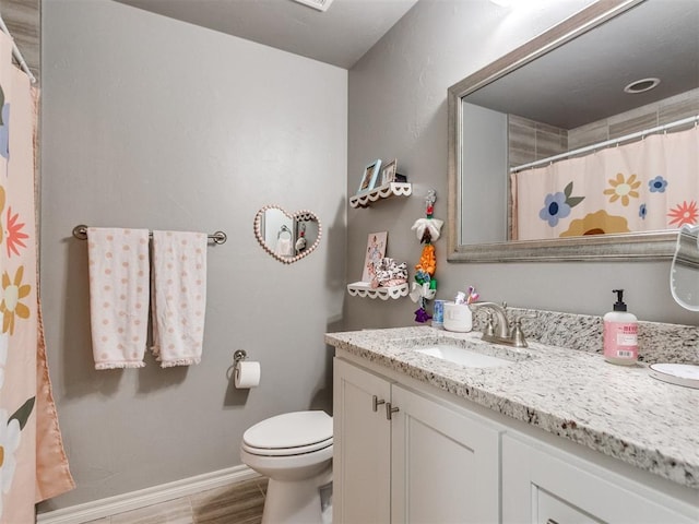 full bath featuring curtained shower, toilet, vanity, wood finished floors, and baseboards