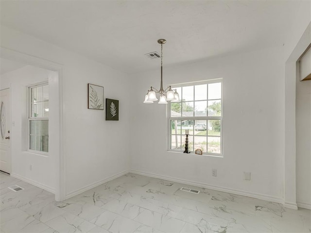 unfurnished dining area with marble finish floor, visible vents, baseboards, and a notable chandelier