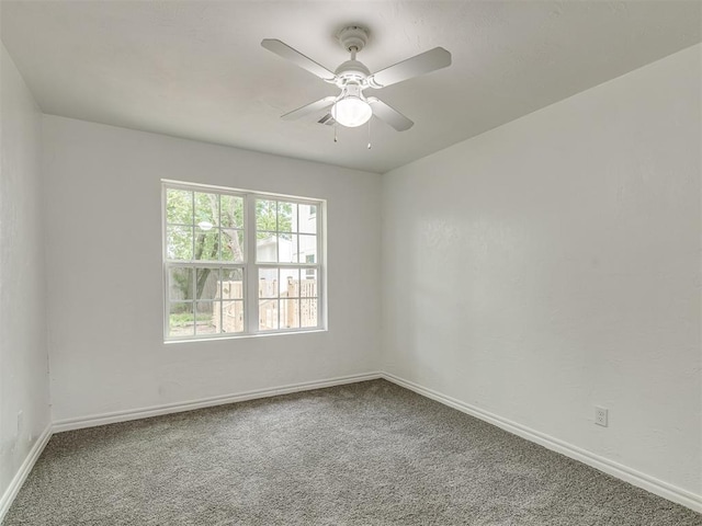 empty room featuring a ceiling fan, carpet flooring, and baseboards