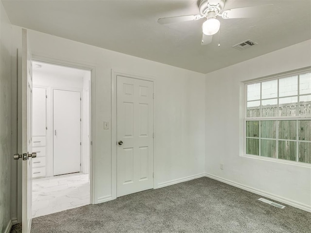 spare room featuring marble finish floor, visible vents, ceiling fan, and baseboards