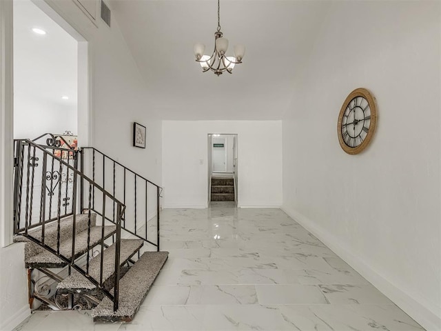 hall featuring stairs, marble finish floor, an inviting chandelier, and baseboards