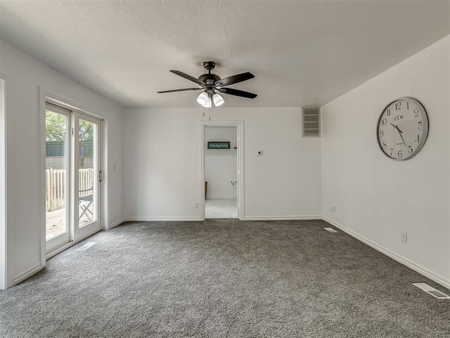 empty room featuring carpet, visible vents, and baseboards