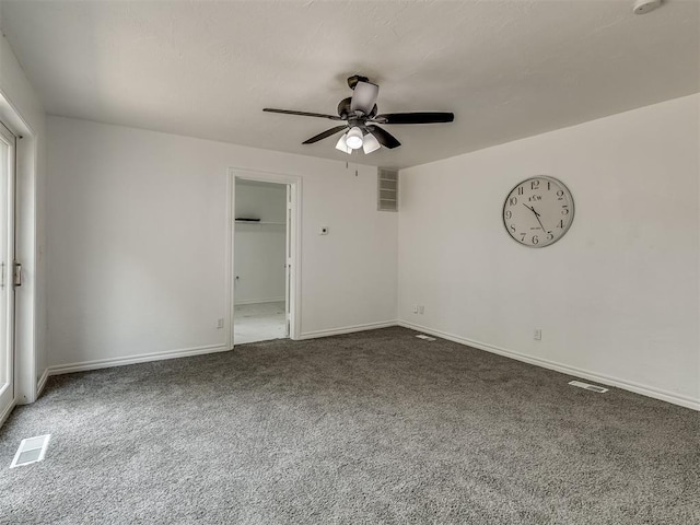 unfurnished room featuring baseboards, ceiling fan, visible vents, and carpet flooring