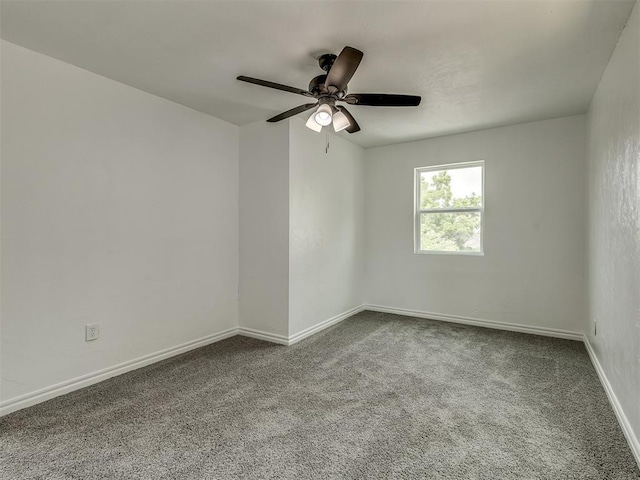 empty room featuring ceiling fan, carpet floors, and baseboards