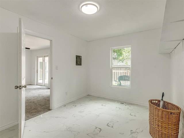 empty room with marble finish floor and baseboards