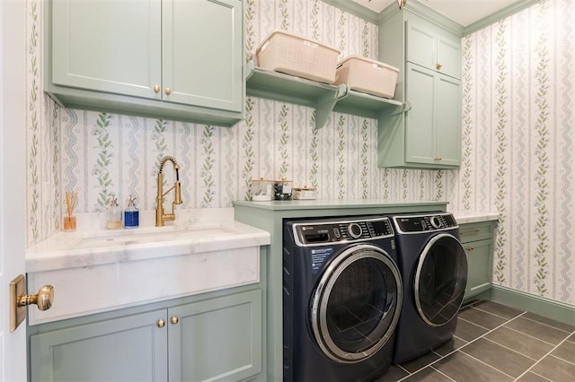 laundry area featuring wallpapered walls, washer and dryer, cabinet space, and dark tile patterned flooring