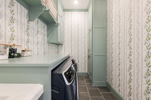 laundry area featuring dark tile patterned flooring, washer and clothes dryer, cabinet space, and wallpapered walls