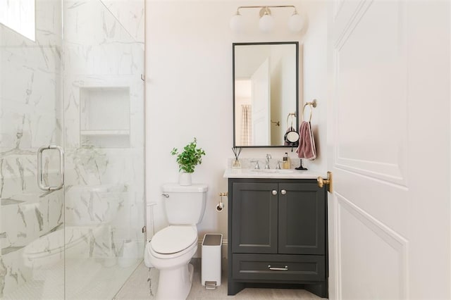 bathroom with toilet, a marble finish shower, and vanity