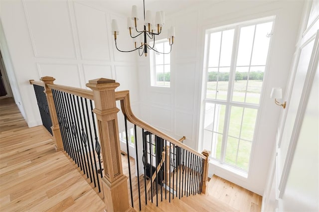 2909 High View Dr, Arcadia, OK 73007 - stairway featuring a decorative wall, a chandelier, plenty of natural light, and wood finished floors