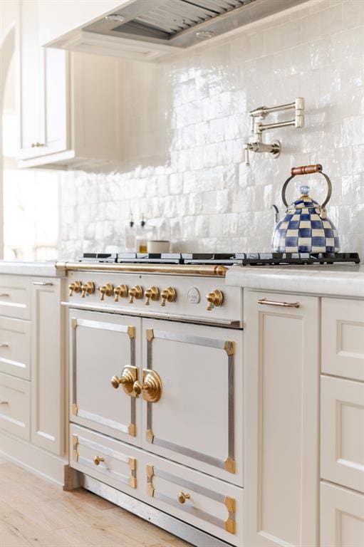 2909 High View Dr, Arcadia, OK 73007 - kitchen featuring decorative backsplash, light countertops, white cabinets, light wood-style floors, and stainless steel range