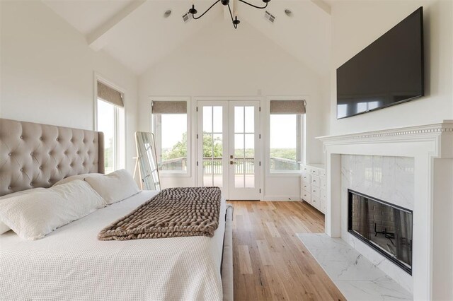 2909 High View Dr, Arcadia, OK 73007 - bedroom with french doors, access to exterior, high vaulted ceiling, a fireplace, and a chandelier