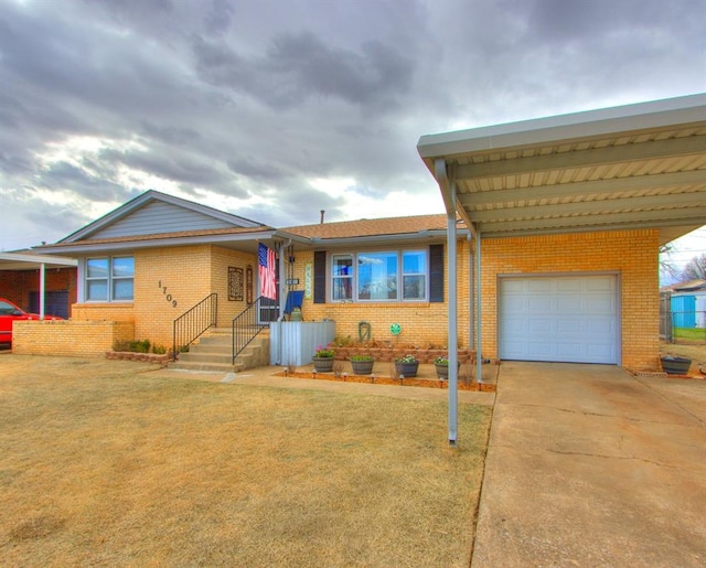 view of front of house featuring concrete driveway, an attached garage, a front lawn, a carport, and brick siding