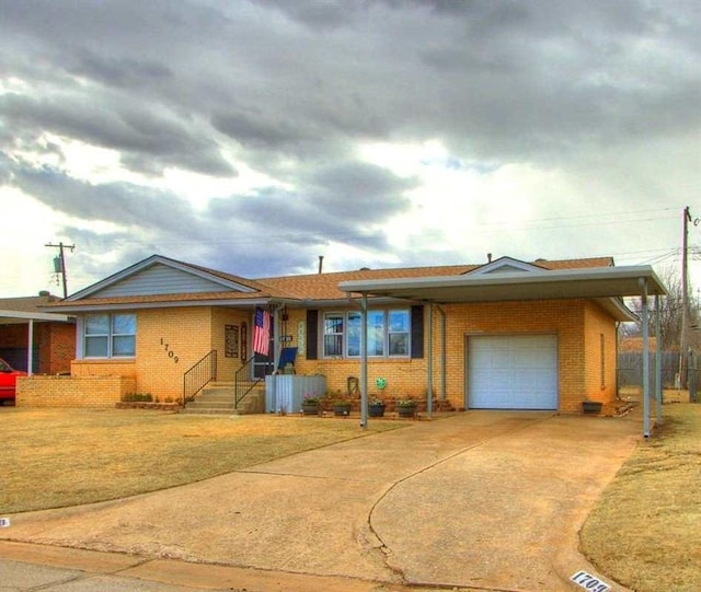 single story home featuring brick siding, concrete driveway, a front yard, fence, and a garage