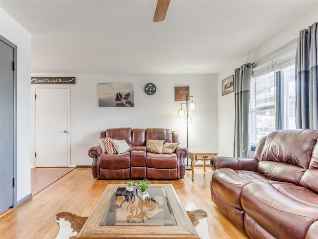 living room with light wood finished floors and ceiling fan