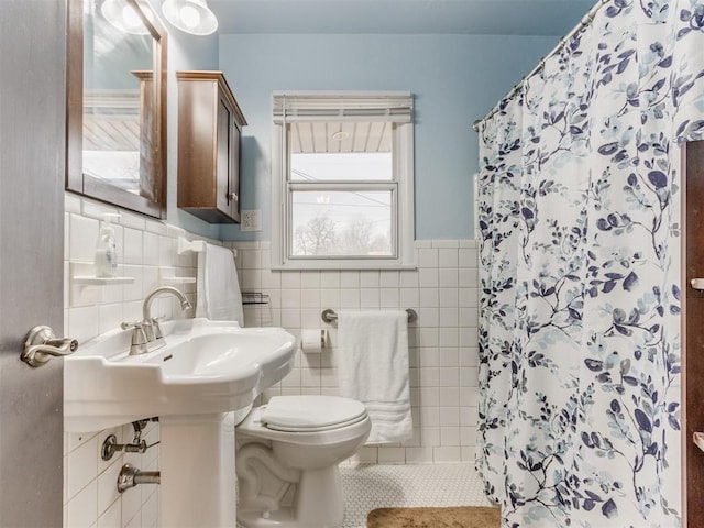 bathroom featuring tile patterned flooring, toilet, tile walls, and a shower with shower curtain