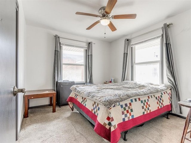 bedroom featuring carpet floors, multiple windows, and ceiling fan