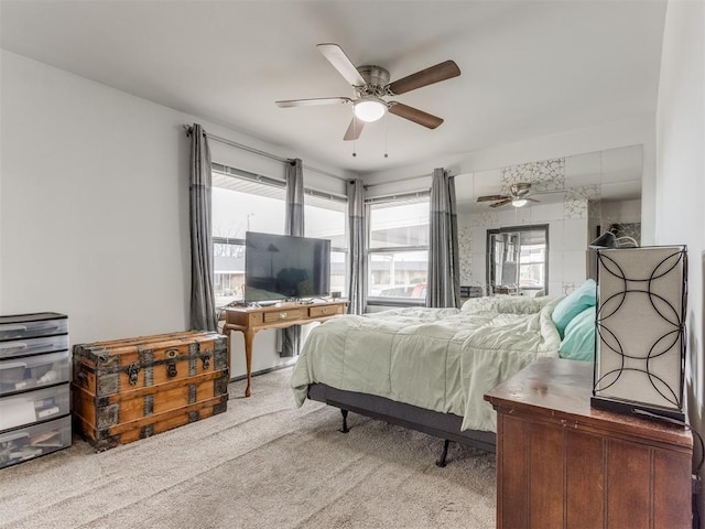 bedroom featuring ceiling fan, carpet floors, and multiple windows