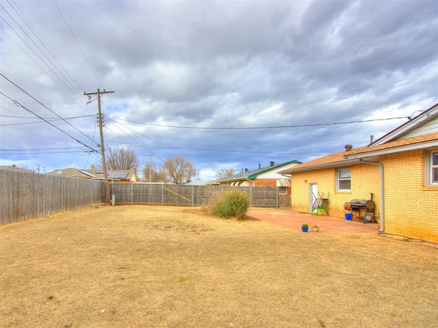 view of yard featuring a patio and a fenced backyard